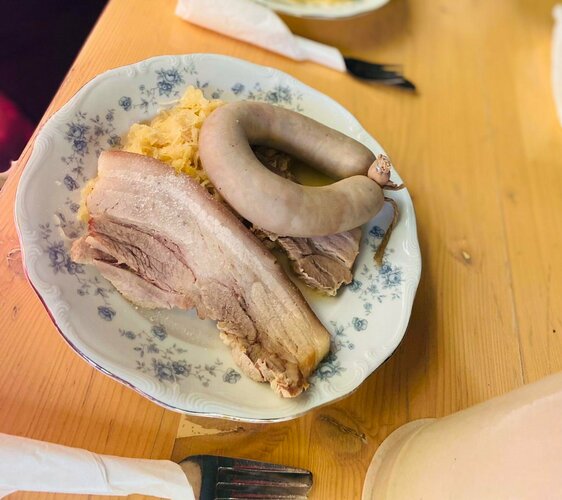 Kesselfleisch und heiße Leberwurst mit Sauerkraut auf einem Teller